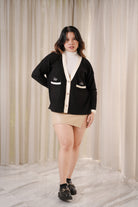 female model in posing in high quality black cardigan by petit moi