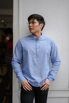 asian man in blue kurta by Petit Moi