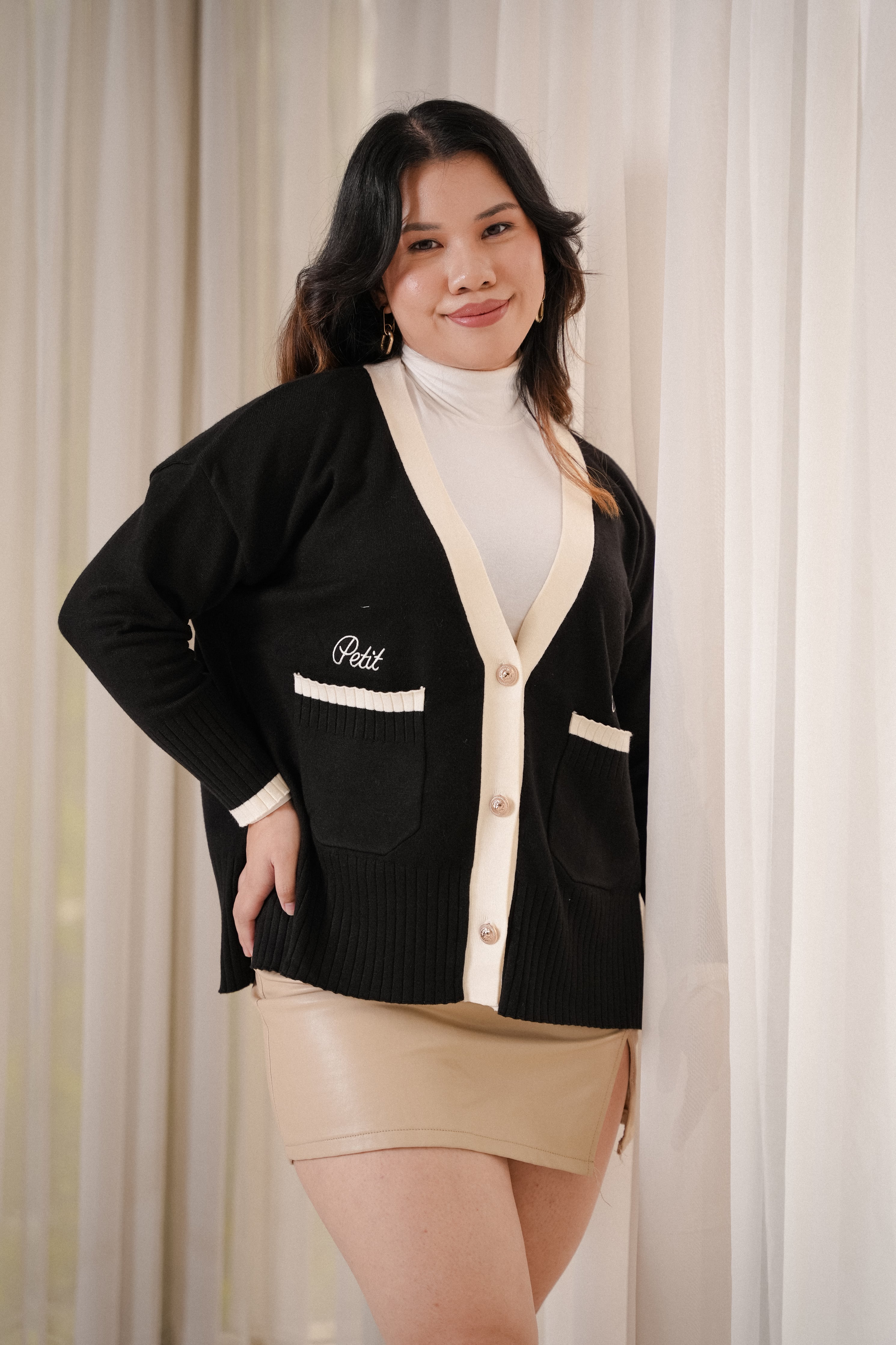 female model posing in high quality black cardigan by petit moi