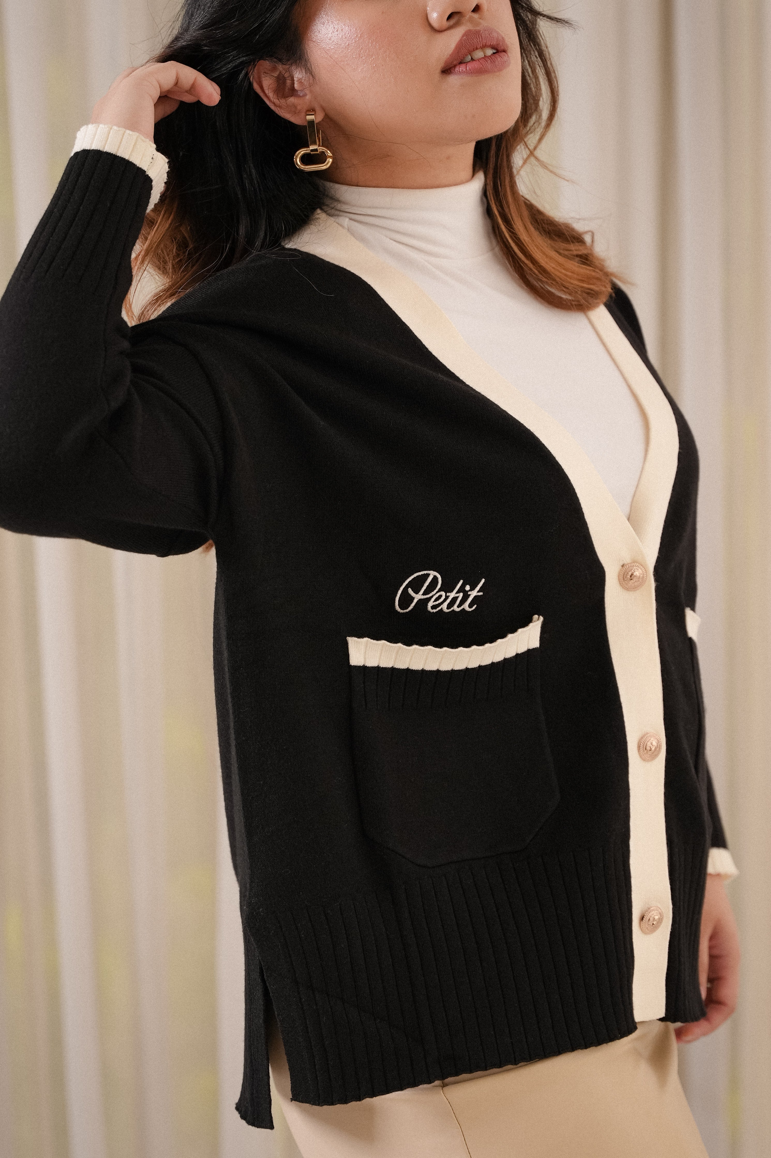 female model posing in high quality black cardigan by petit moi