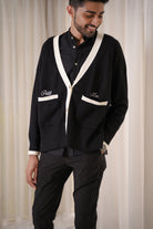 male model posing in black cardigan made by petit moi