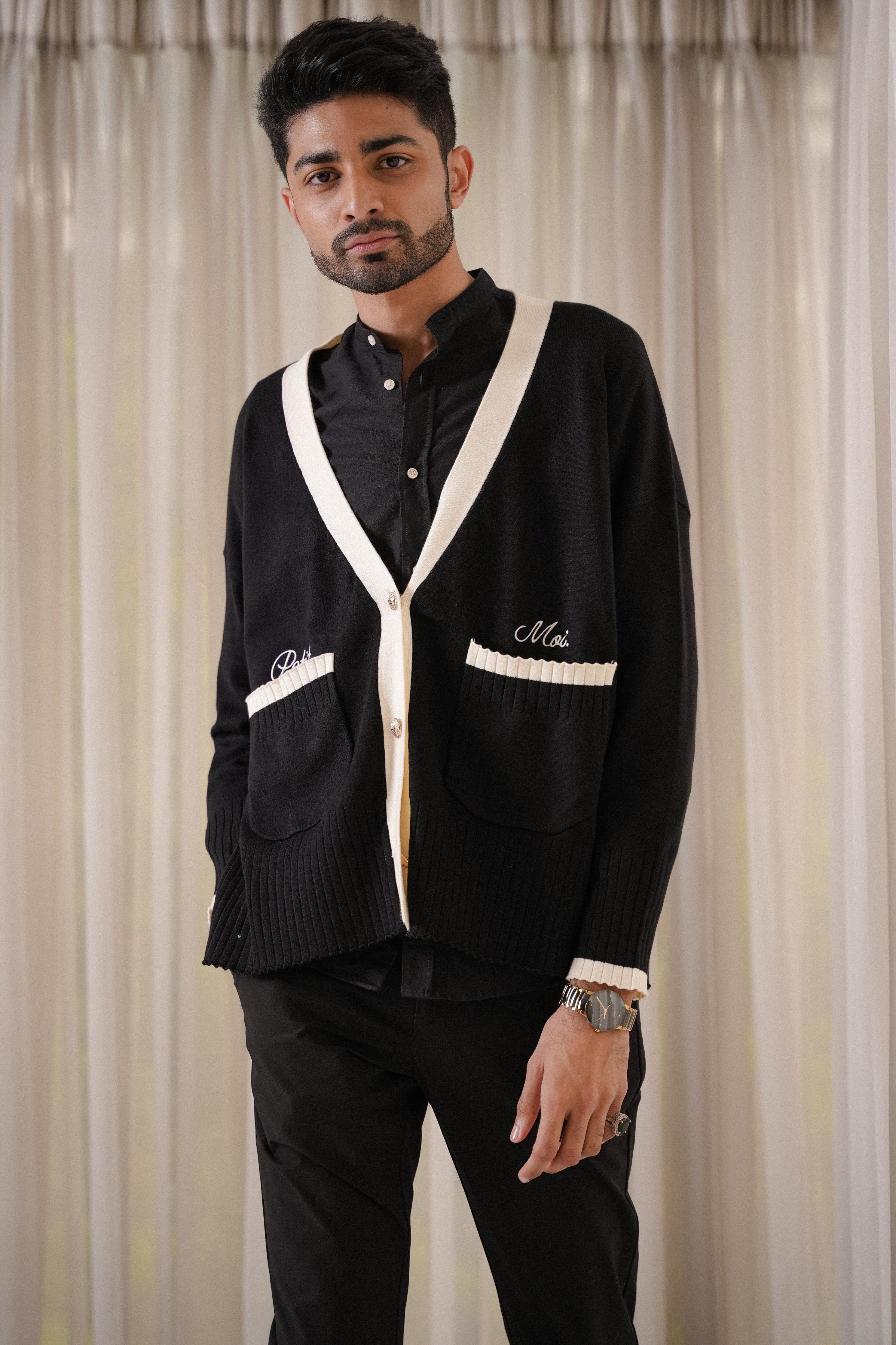 male model posing in black cardigan made by petit moi