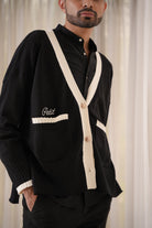 male model posing in black cardigan made by petit moi