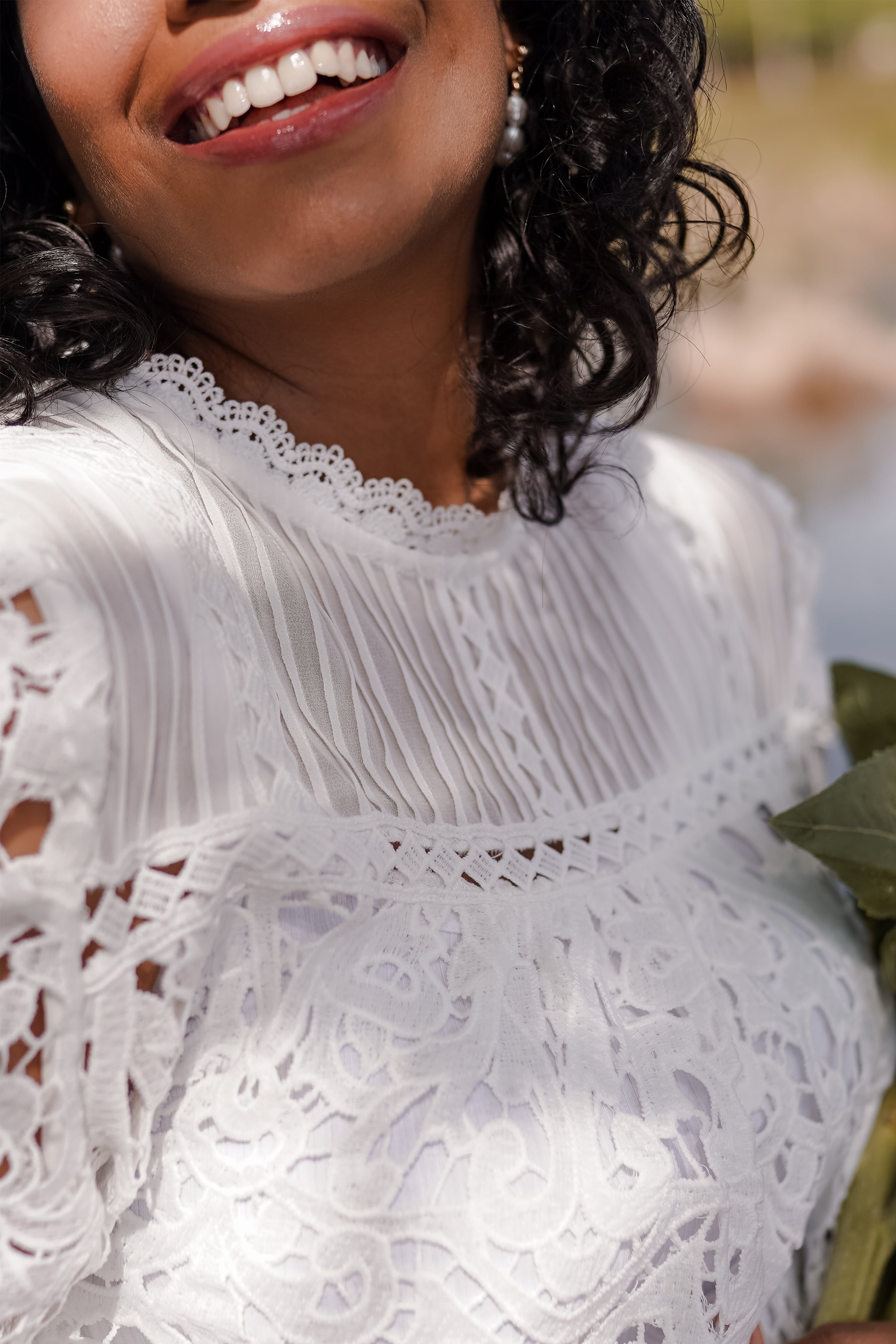 Closeup shot of female model wearing high quality laced top made by petit moi