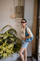 woman in petit moi jumper posing for photo