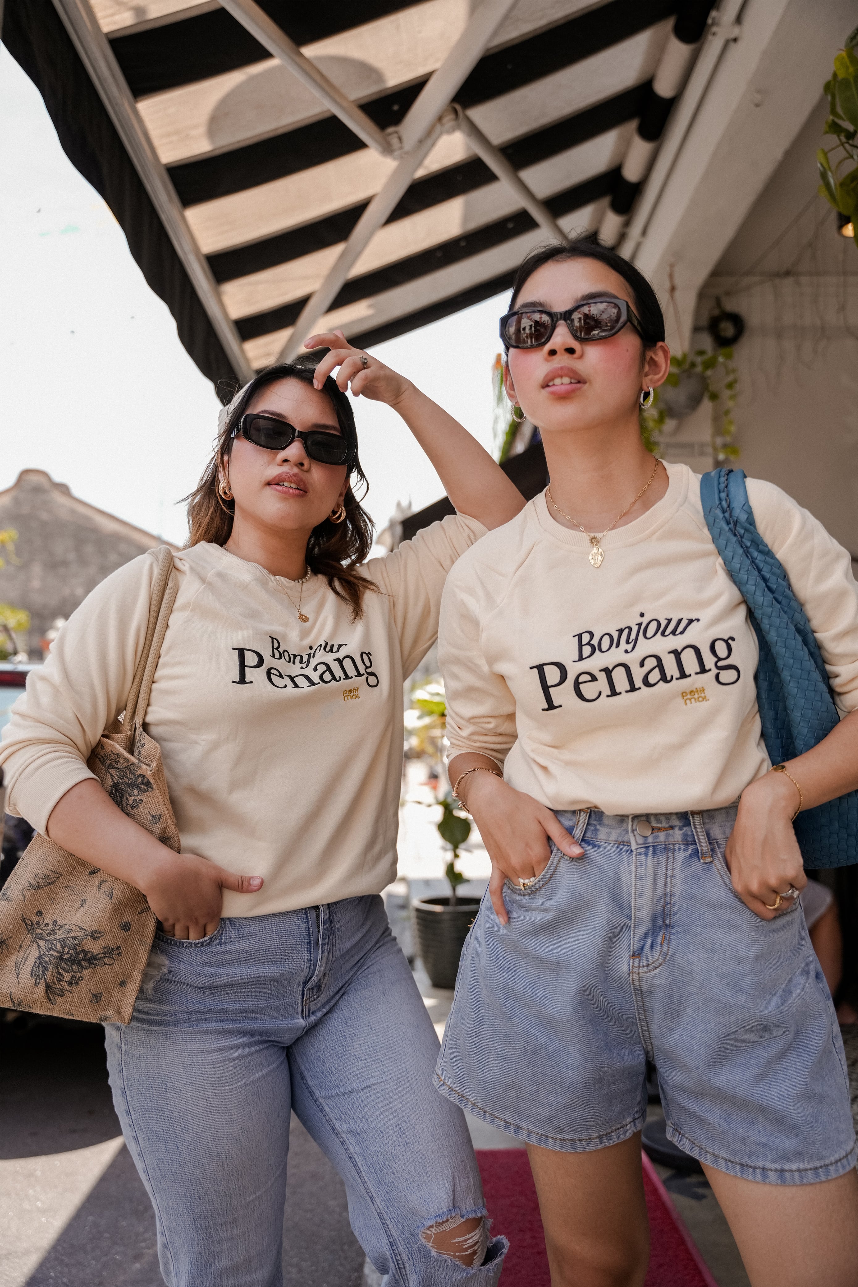 two female models posing in petit moi jumper