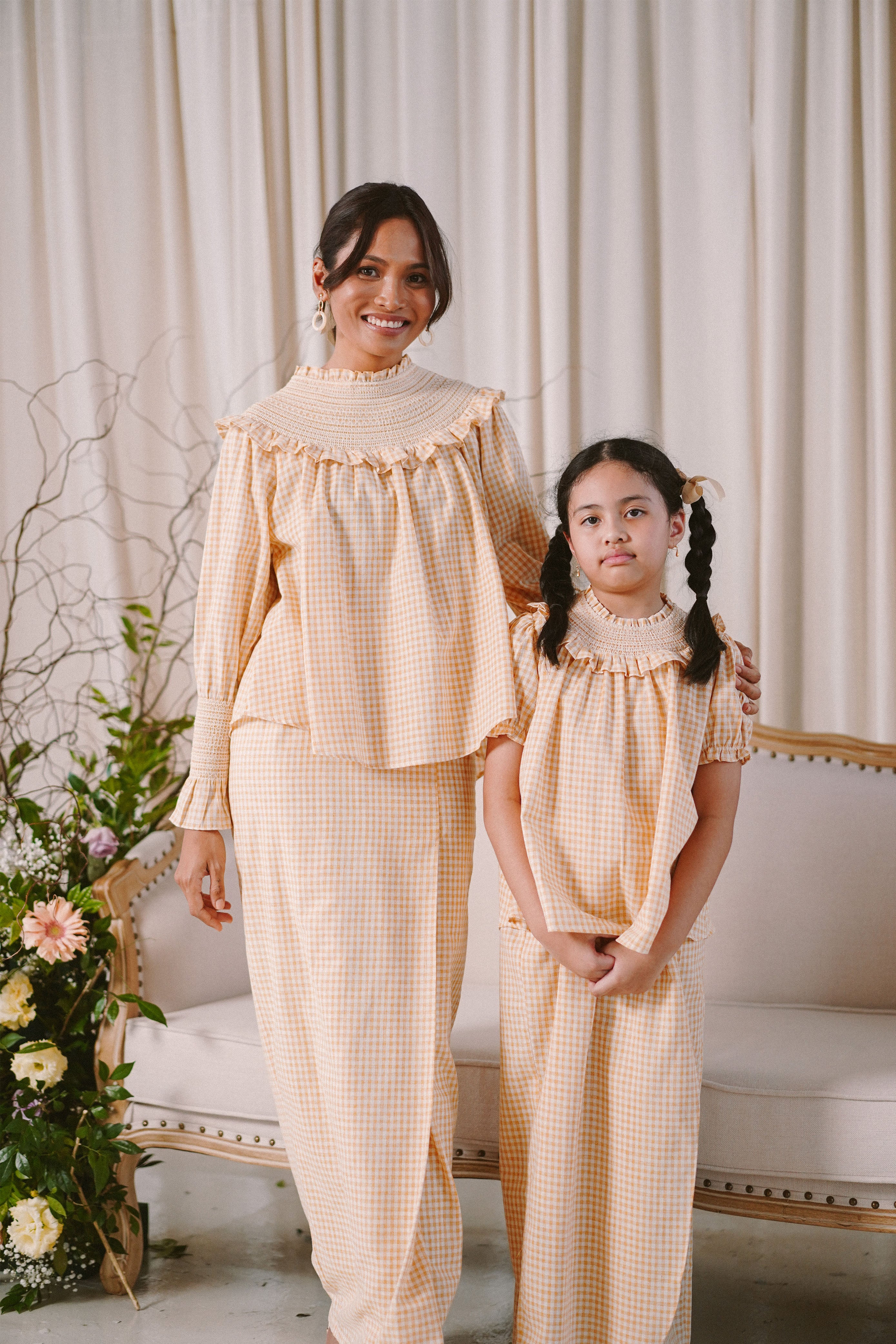 Mother and daughter in matching baju kurung by Petit Moi