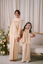 Mother and daughter in matching baju kurung by Petit Moi
