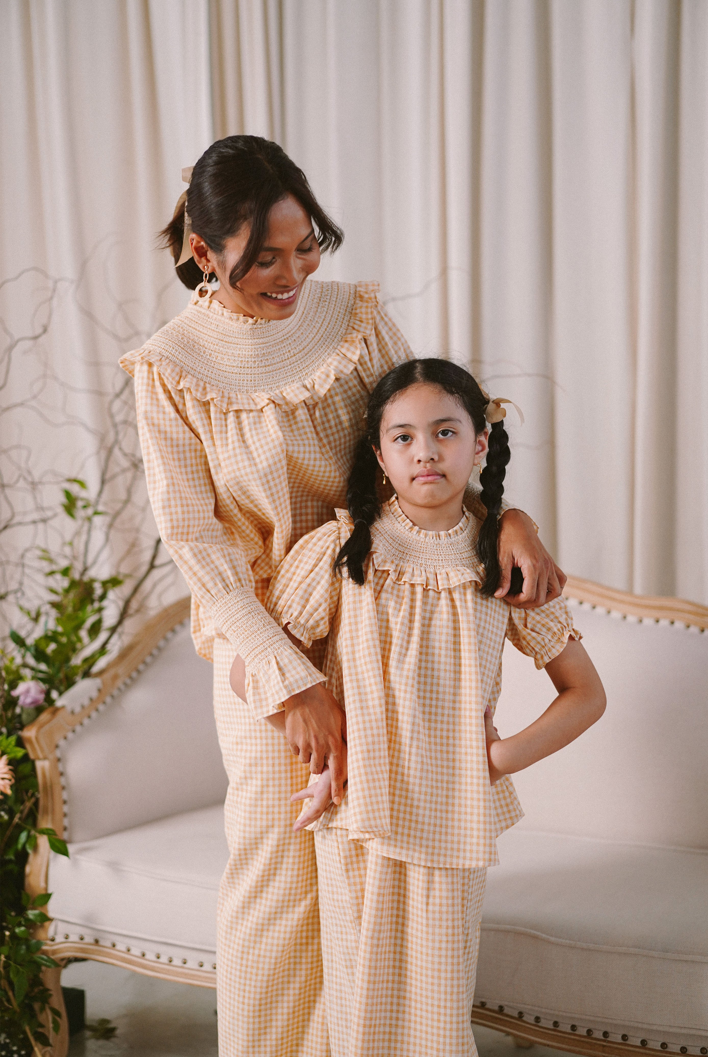 Mother and daughter in high quality matching baju kurung by Petit Moi