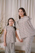 Mother and daughter holding hands and wearing matching clothes by petit moi