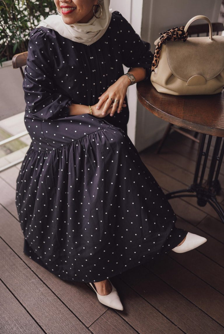 female model in high quality black polka dress made by petit moi