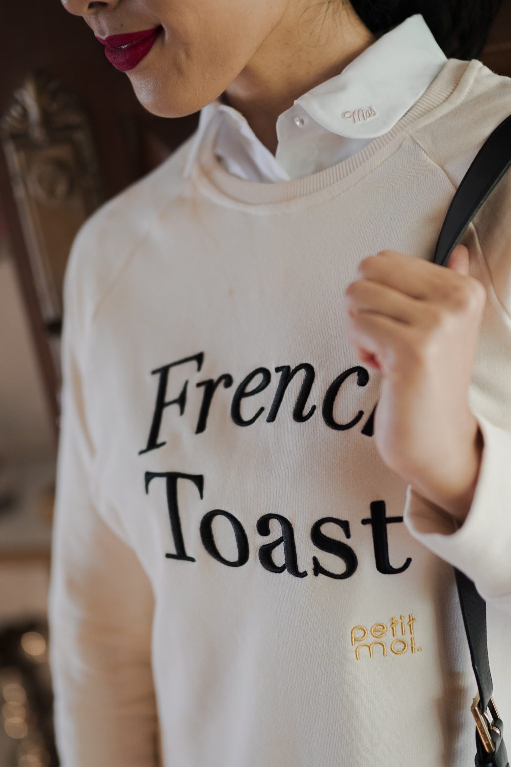 Closeup shot of female model in high quality sweater made by petit moi