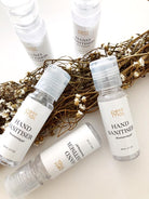 High quality hand sanitisers made by petit moi. arranged on white table with props