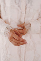 hands in ruffled baju kurung