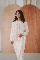 woman in high quality white baju kurung