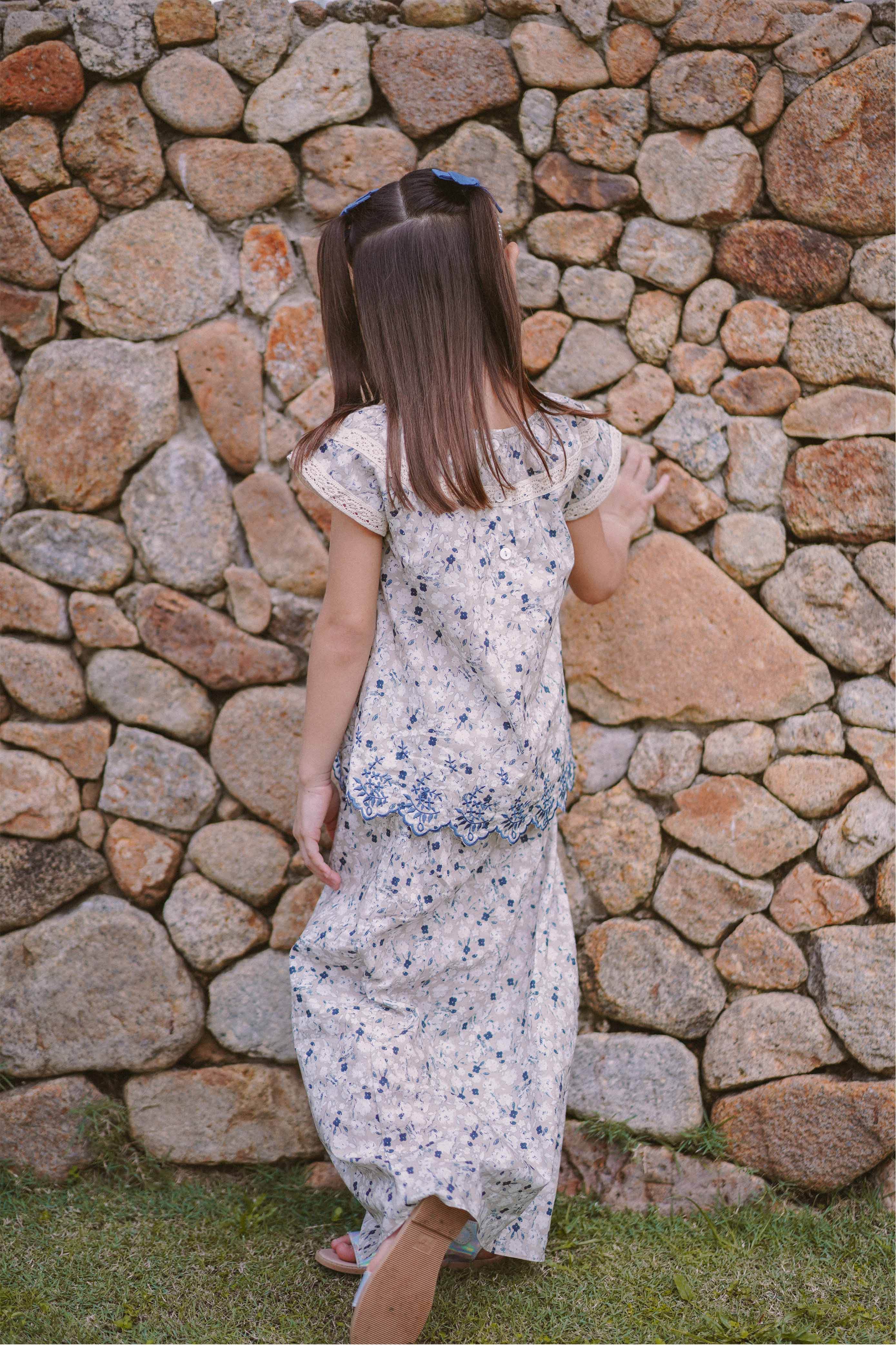Little girl in high quality flowery baju kurung by Petit Moi