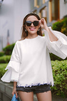 female model in sunglasses and casual white top by petit moi