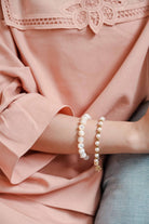 Female model wearing high quality pink baju kurung and bracelets made by petit moi