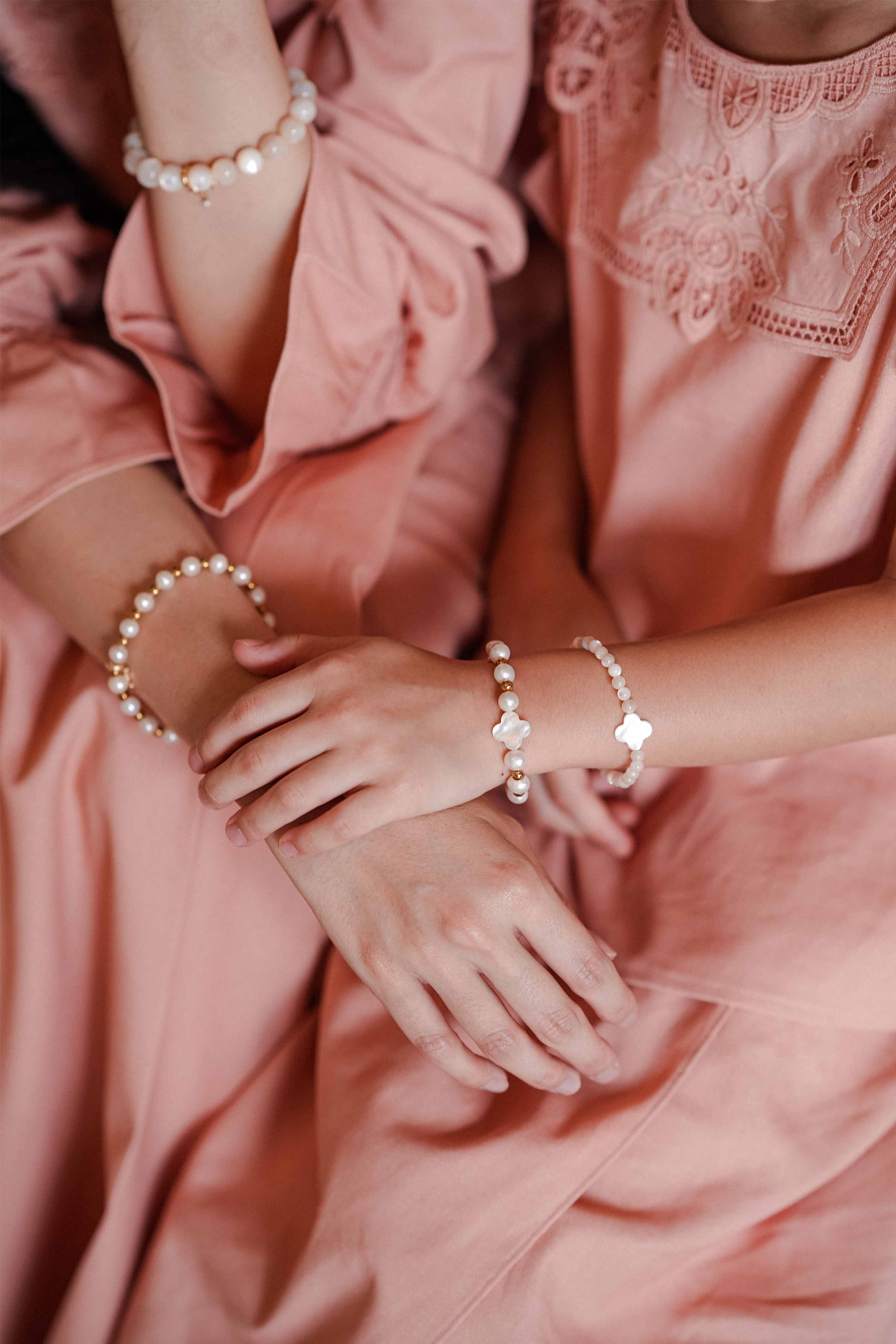 Mother and daughter in high quality matching pink baju kurung and bracelet by petit moi