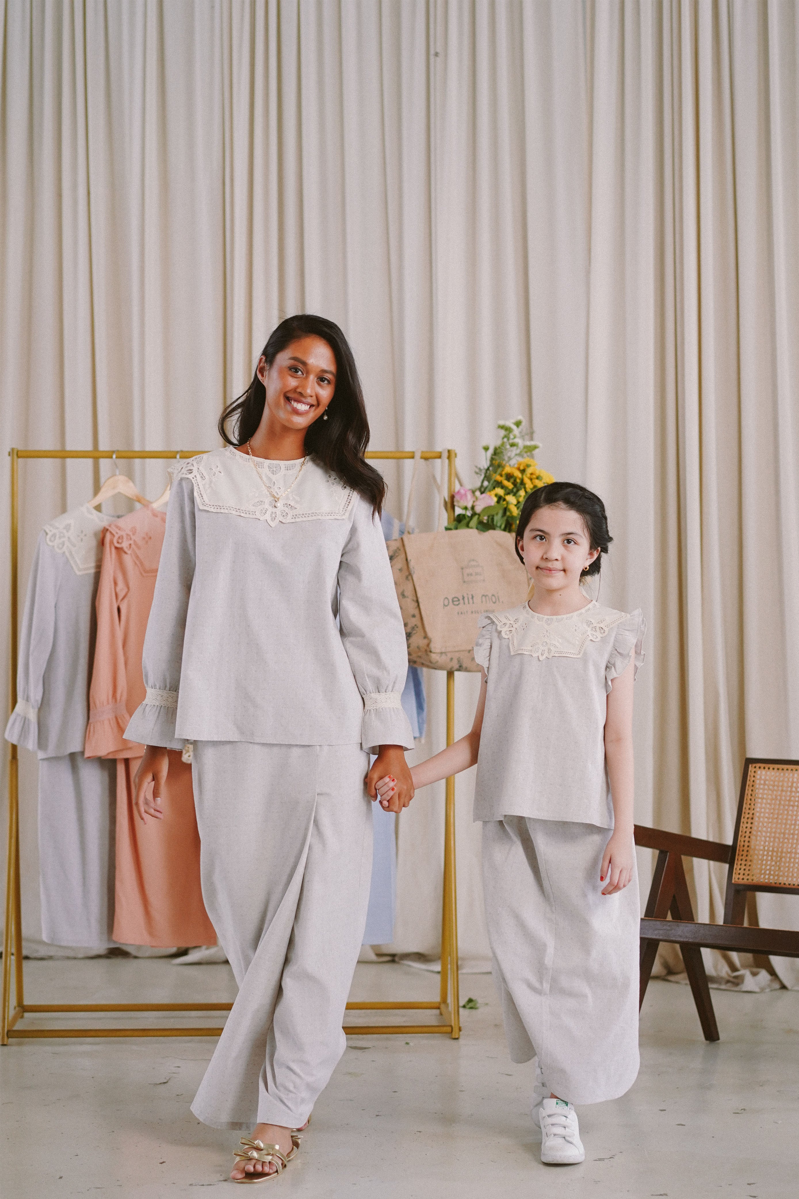Sisters wearing matching high quality clothes by petit moi