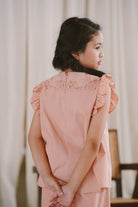 little girl modelling in her favourite pink dress made by petit moi