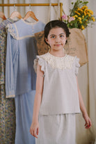 Happy girl smiling in her favourite light blue dress by petit moi