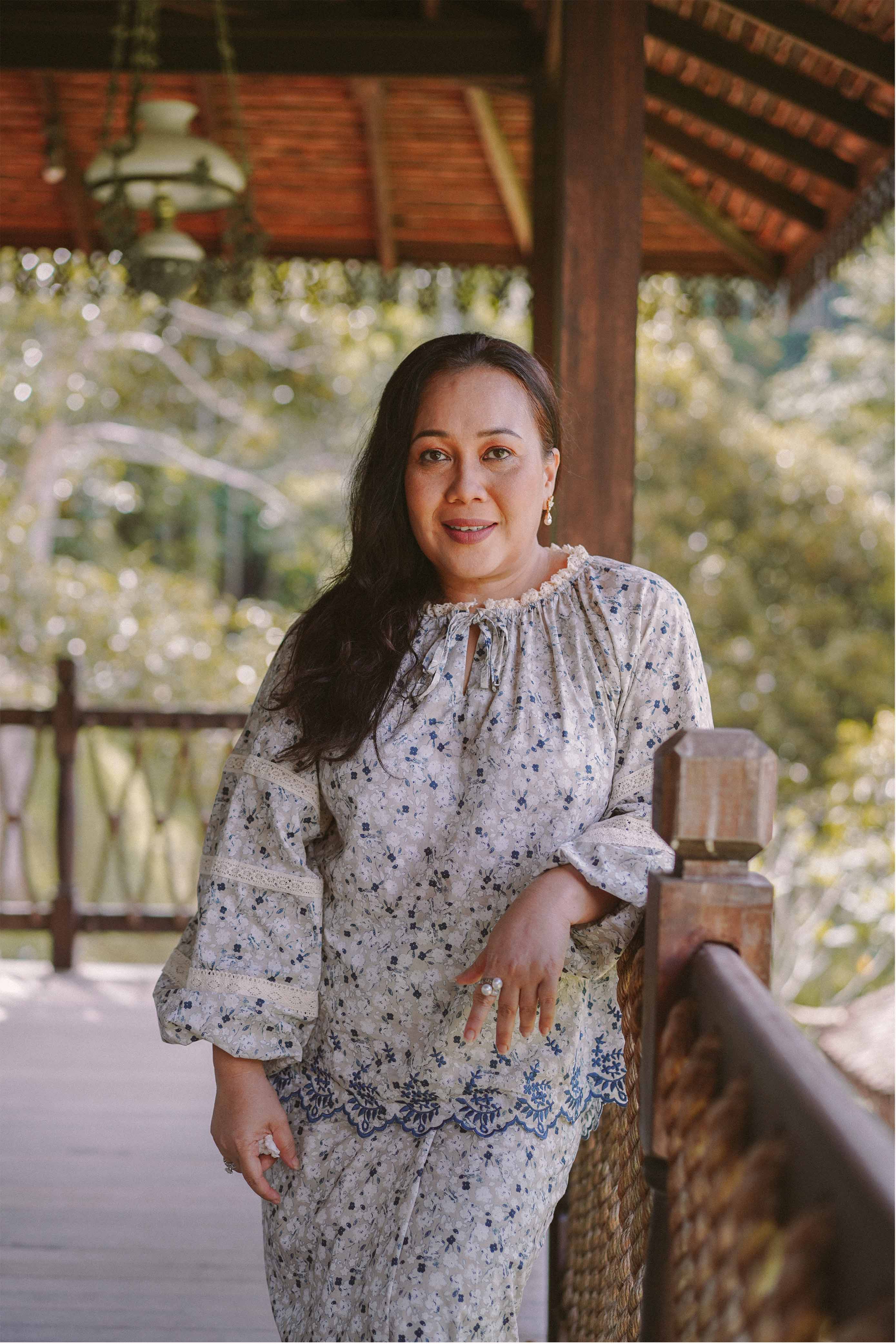 mature woman wearing blue floral baju kurung by petit moi