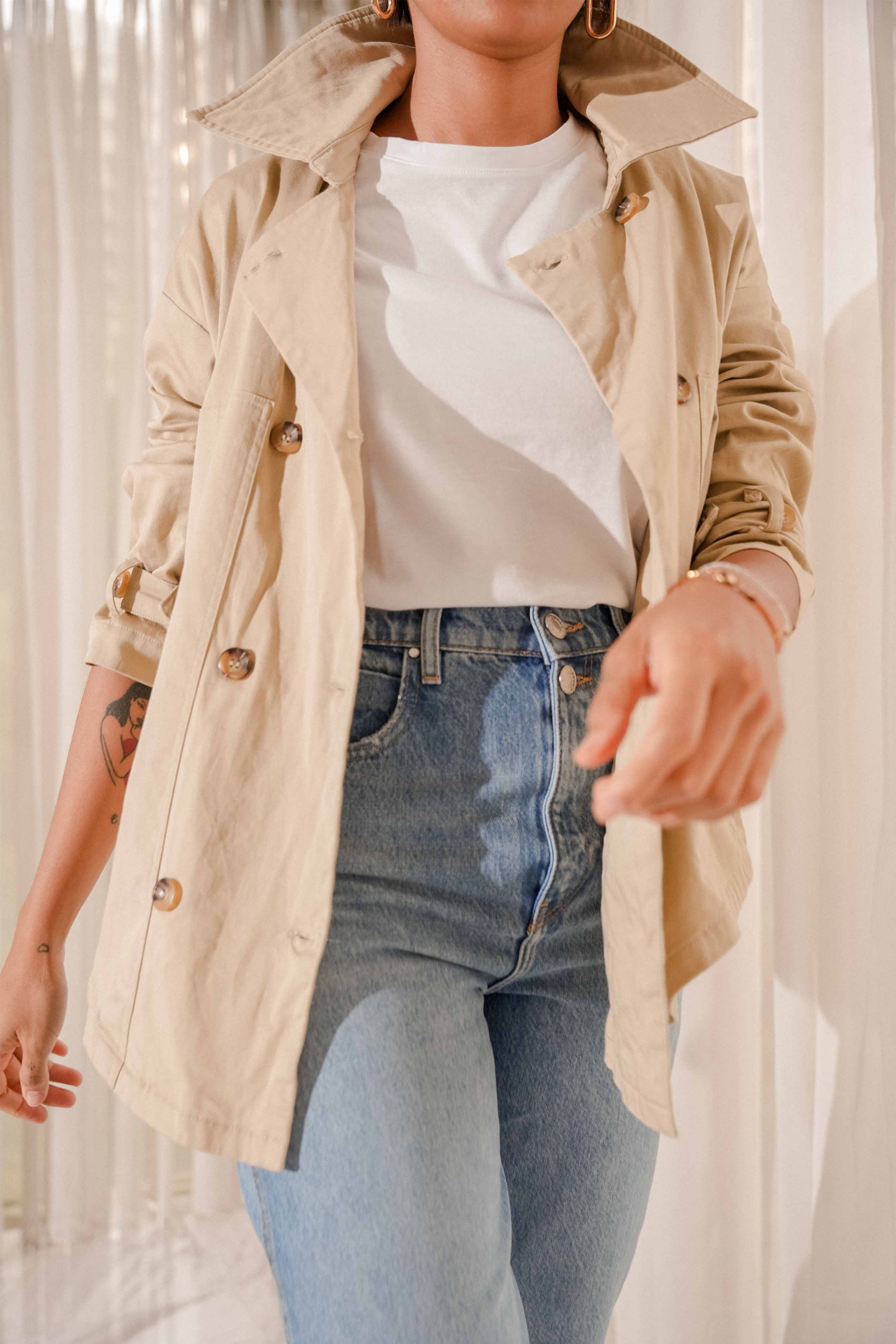 woman posing in her high quality trench coat made by petit moi