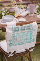 Petit Moi green bingka towel hanging on chair
