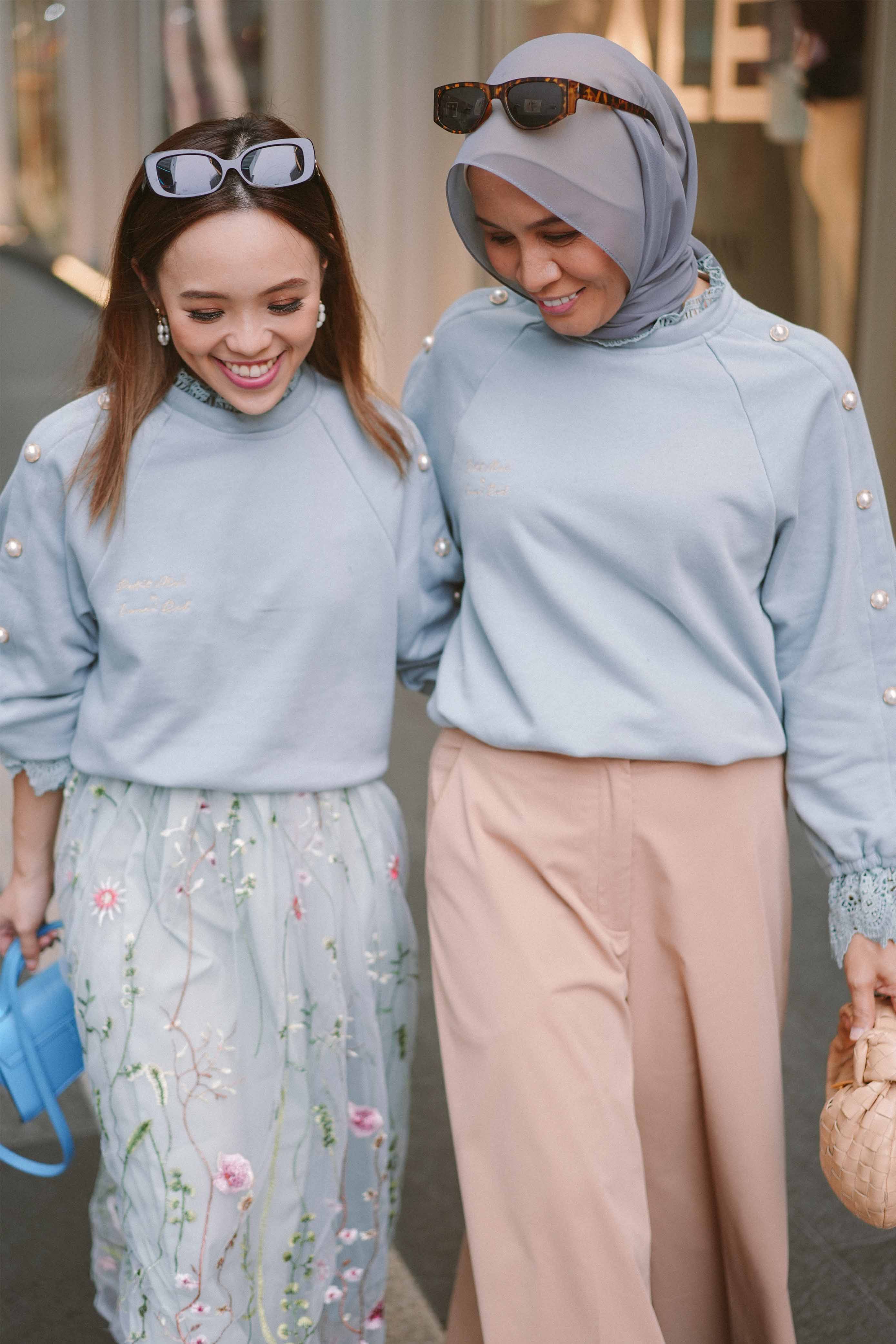 two best friends wearing matching tops designed by petit moi