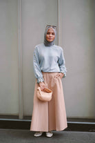 female model wearing blue top designed by petit moi