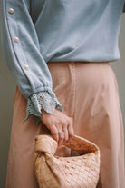 closeup shot of outfit worn by female model, designed by petit moi