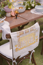 petit moi bingka yellow tea towel on chair