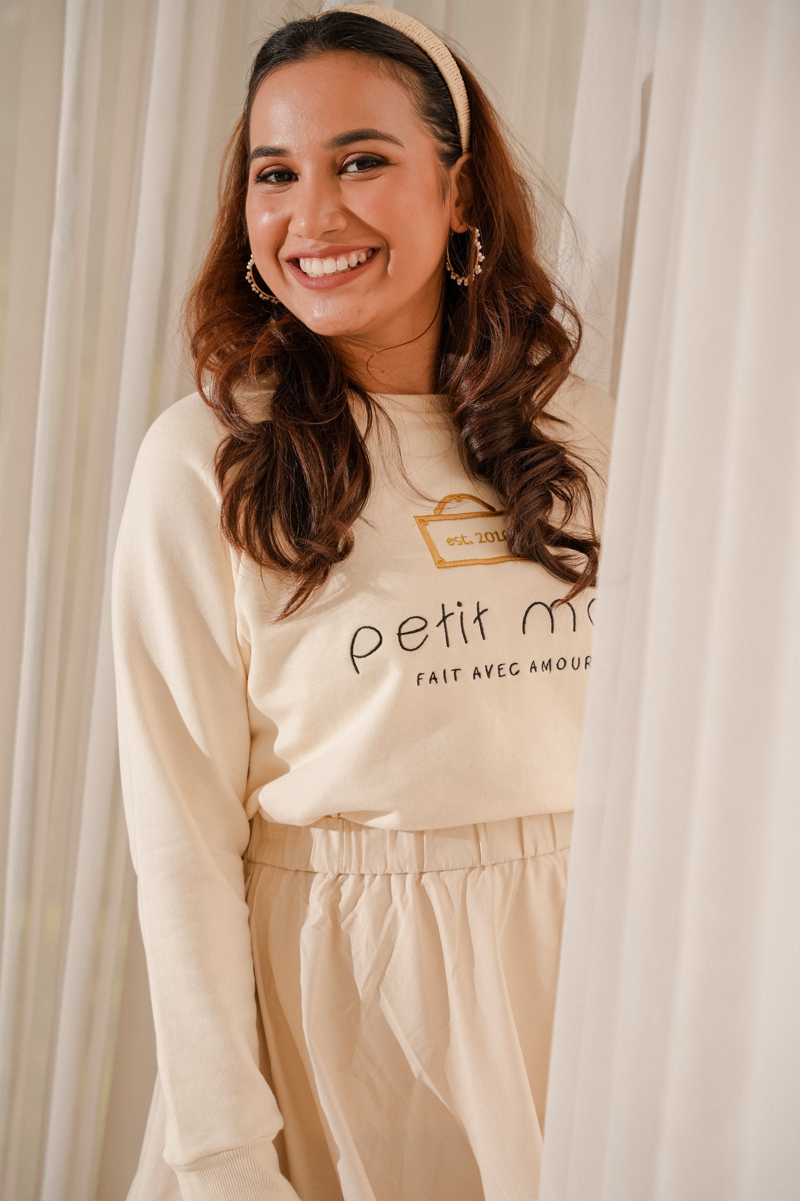 female model happily smiling in her new high quality jumper made by petit moi