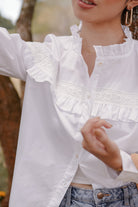 closeup shot of female model in white blouse made by petit moi