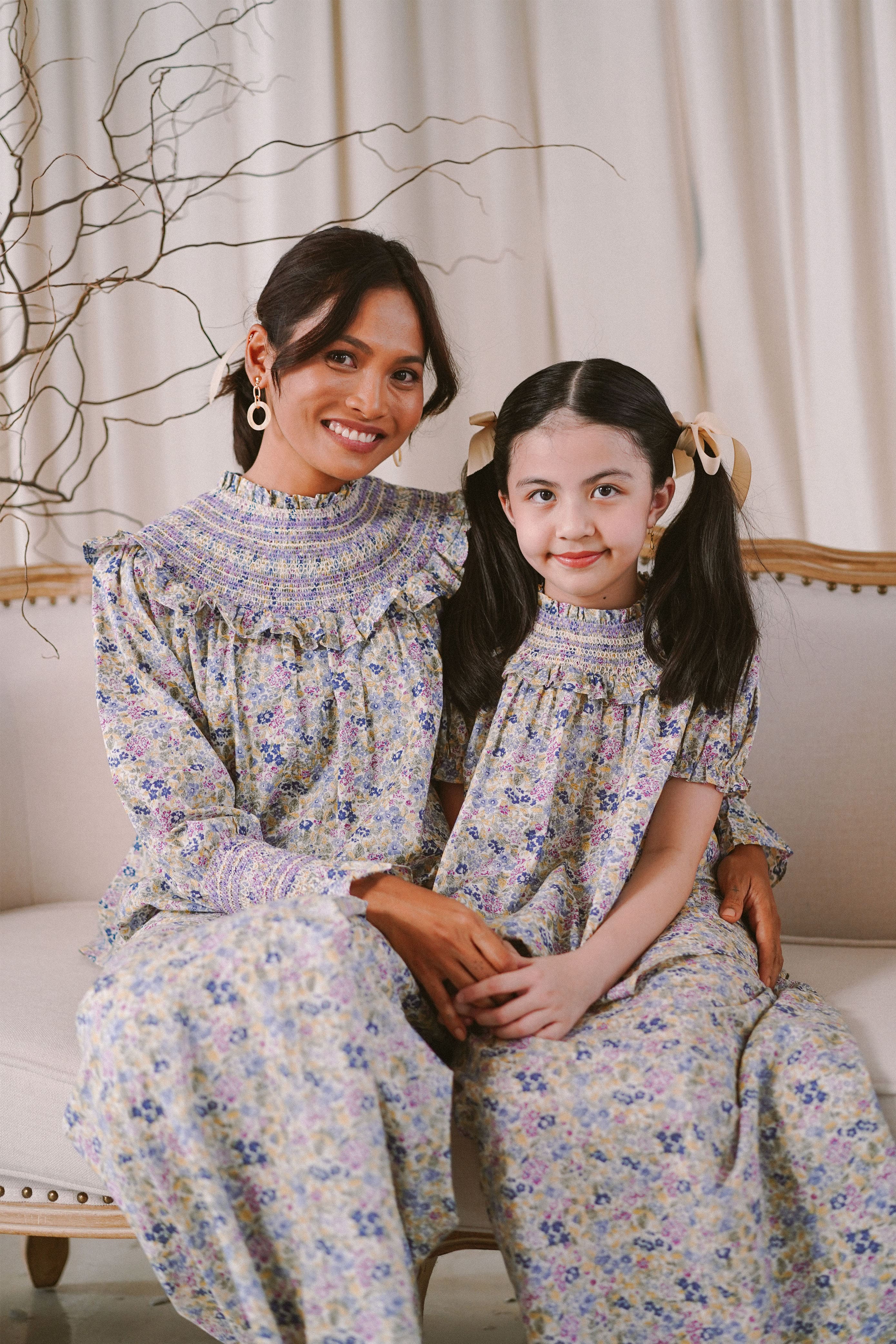 mother and daughter in baju kurung by petit moi smiling for the camera