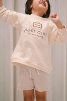 little kid modelling in high quality sweater made by petit moi