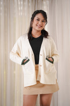 female model posing in high quality white and forest green cardigan made by petit moi