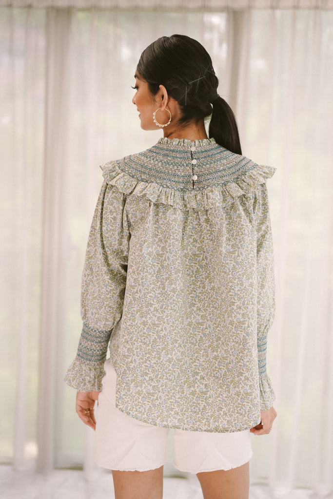 Back shot of female model posing in high quality modest top made by petit moi