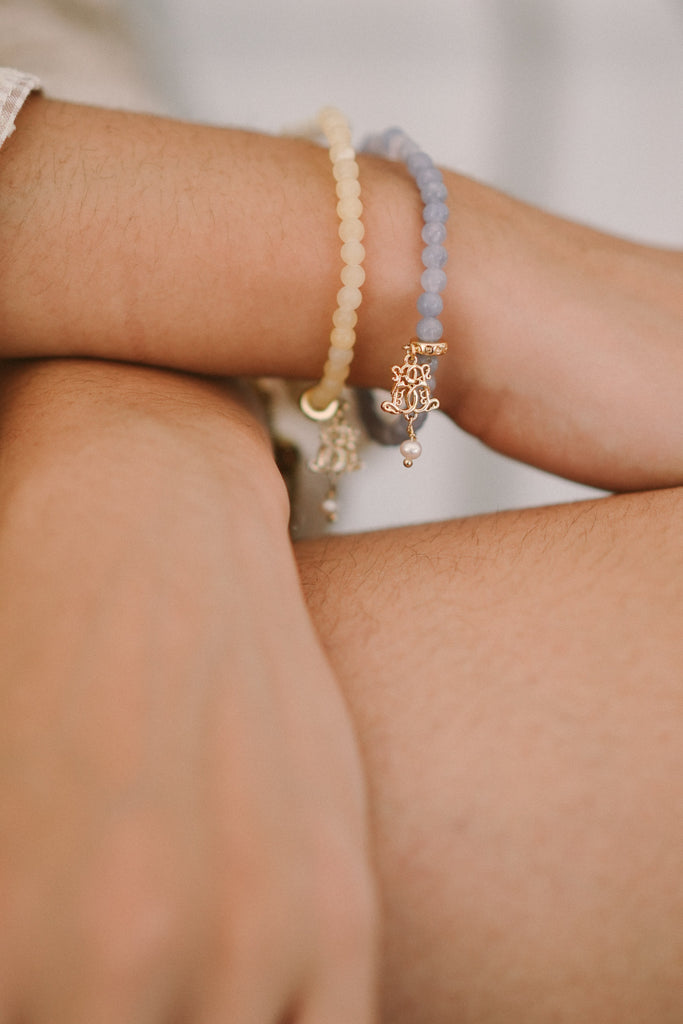 assorted bracelets worn by hand model for product shot