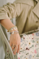 hand model wearing assorted bracelets designed by petit moi