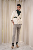 male model posing in high quality white and forest green cardigan made by petit moi