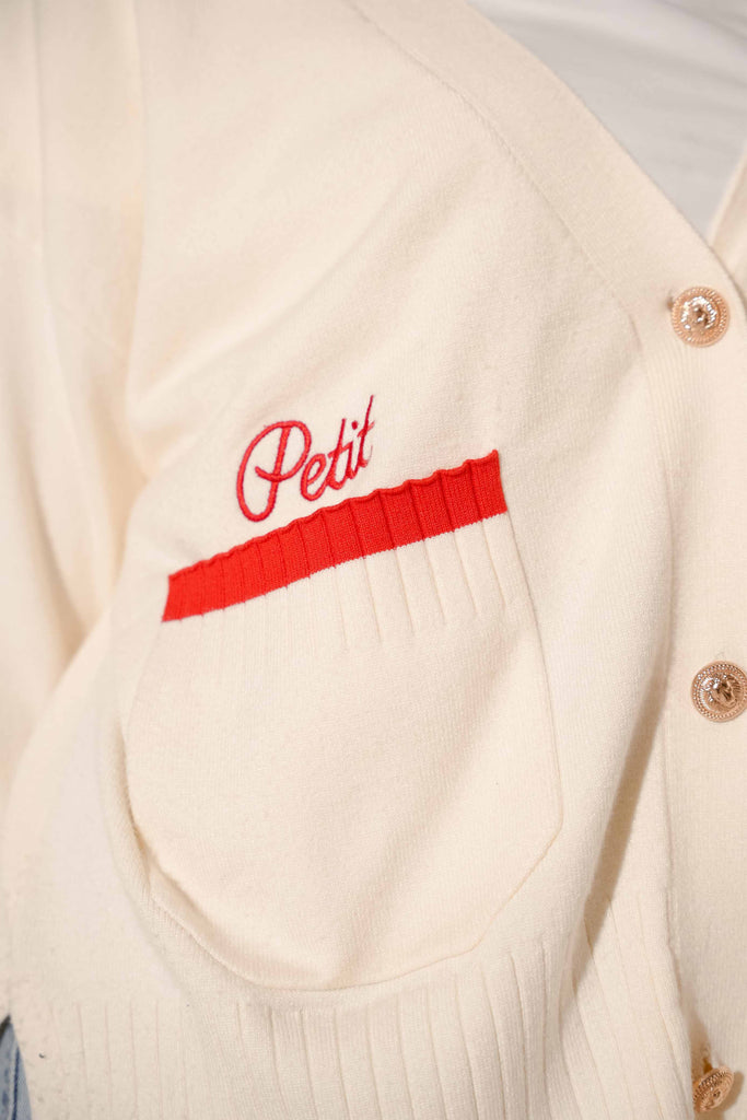 Petit Moi logo on a high quality white and red cardigan 