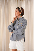 Female model posing in Chambray shirt by Petit Moi