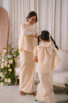 Mother and daughter in matching baju kurung by Petit Moi