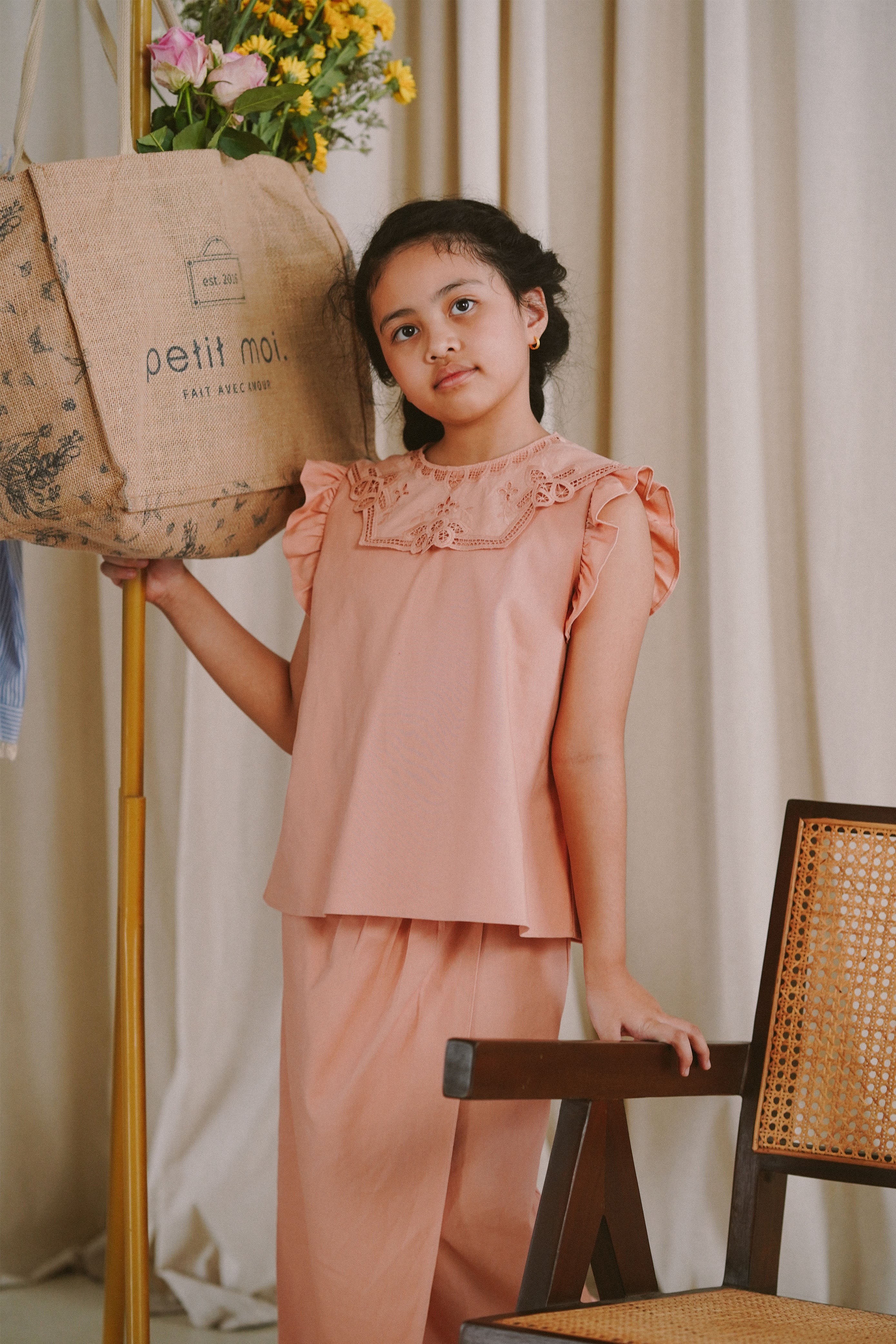 Little girl posing in pink baju kurung made by petit moi