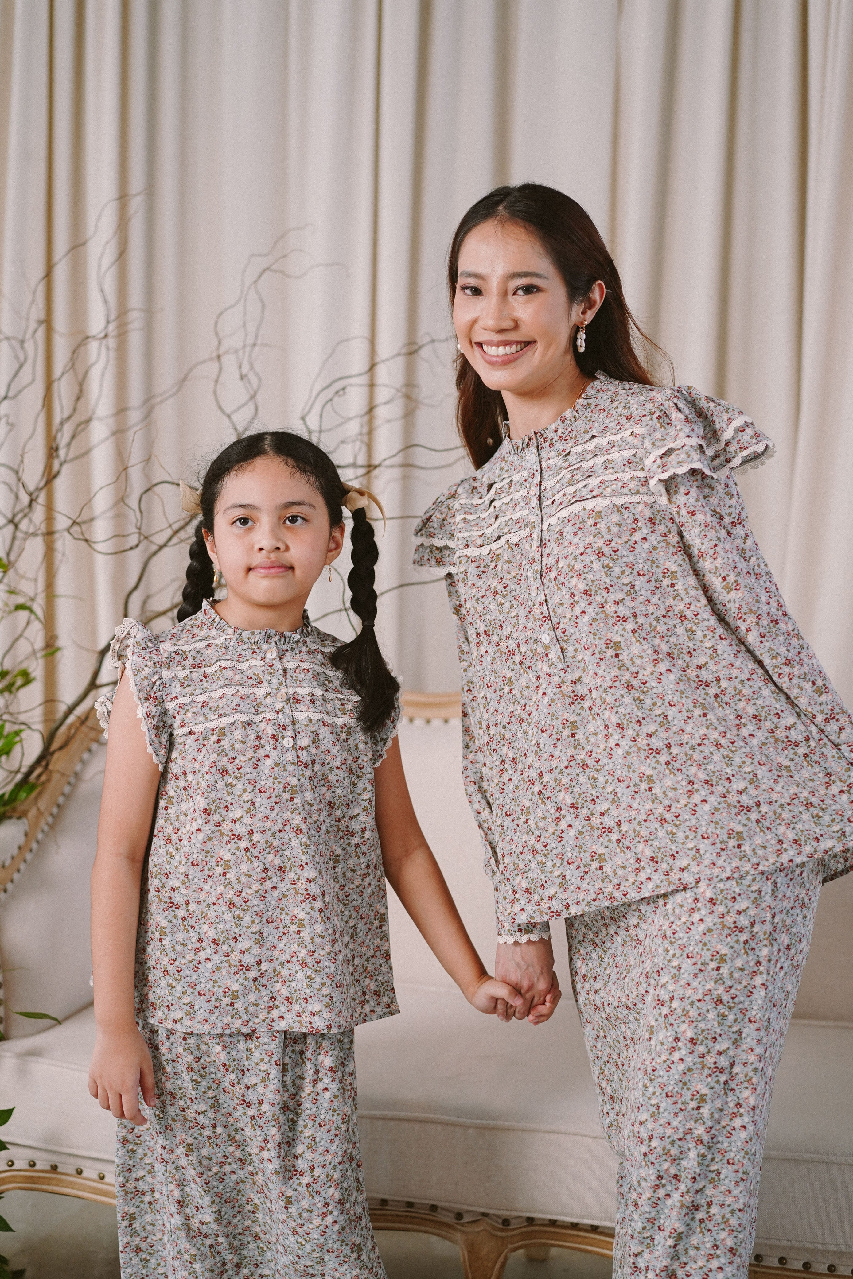 Mother and daughter holding hands and wearing matching clothes by petit moi