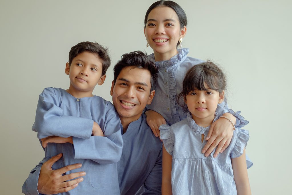 happy family in blue kurta and baju kurung