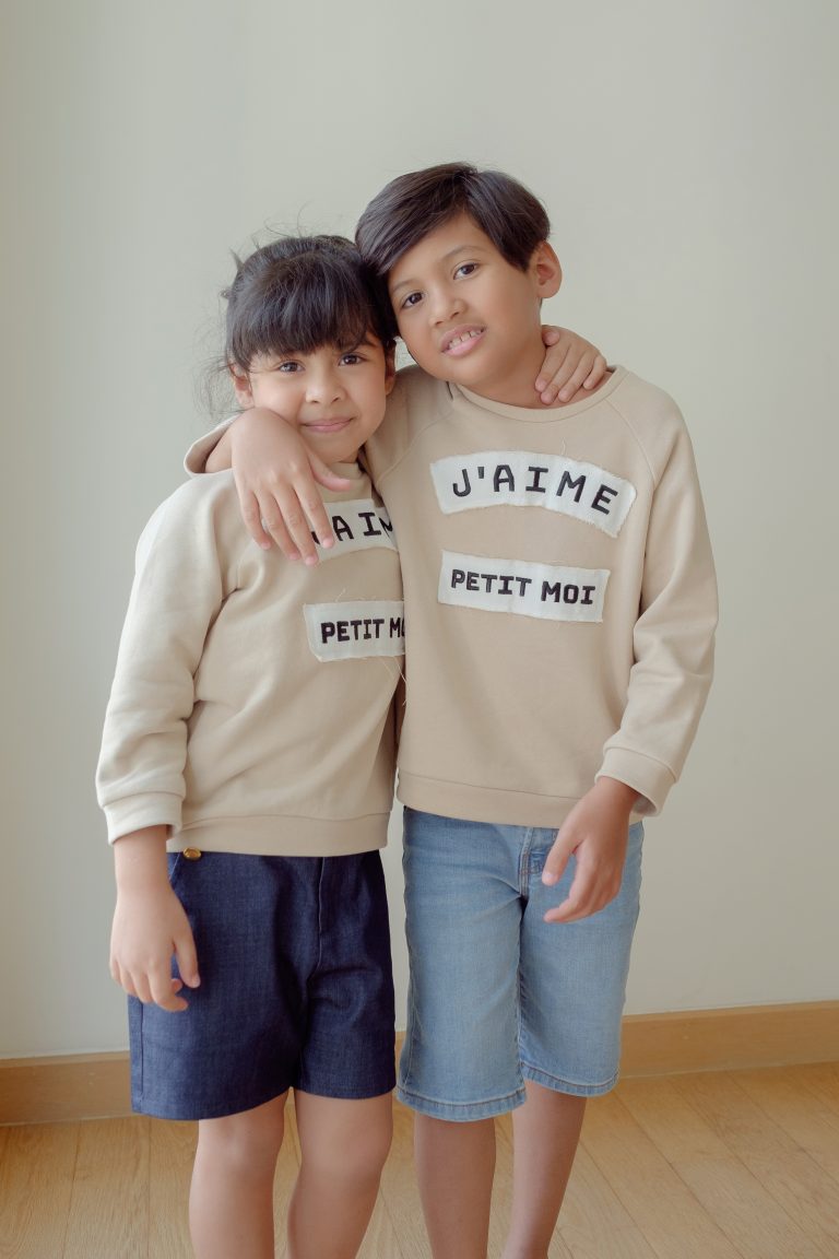 Brother and sister in high quality matching jumpers made by petit moi.
