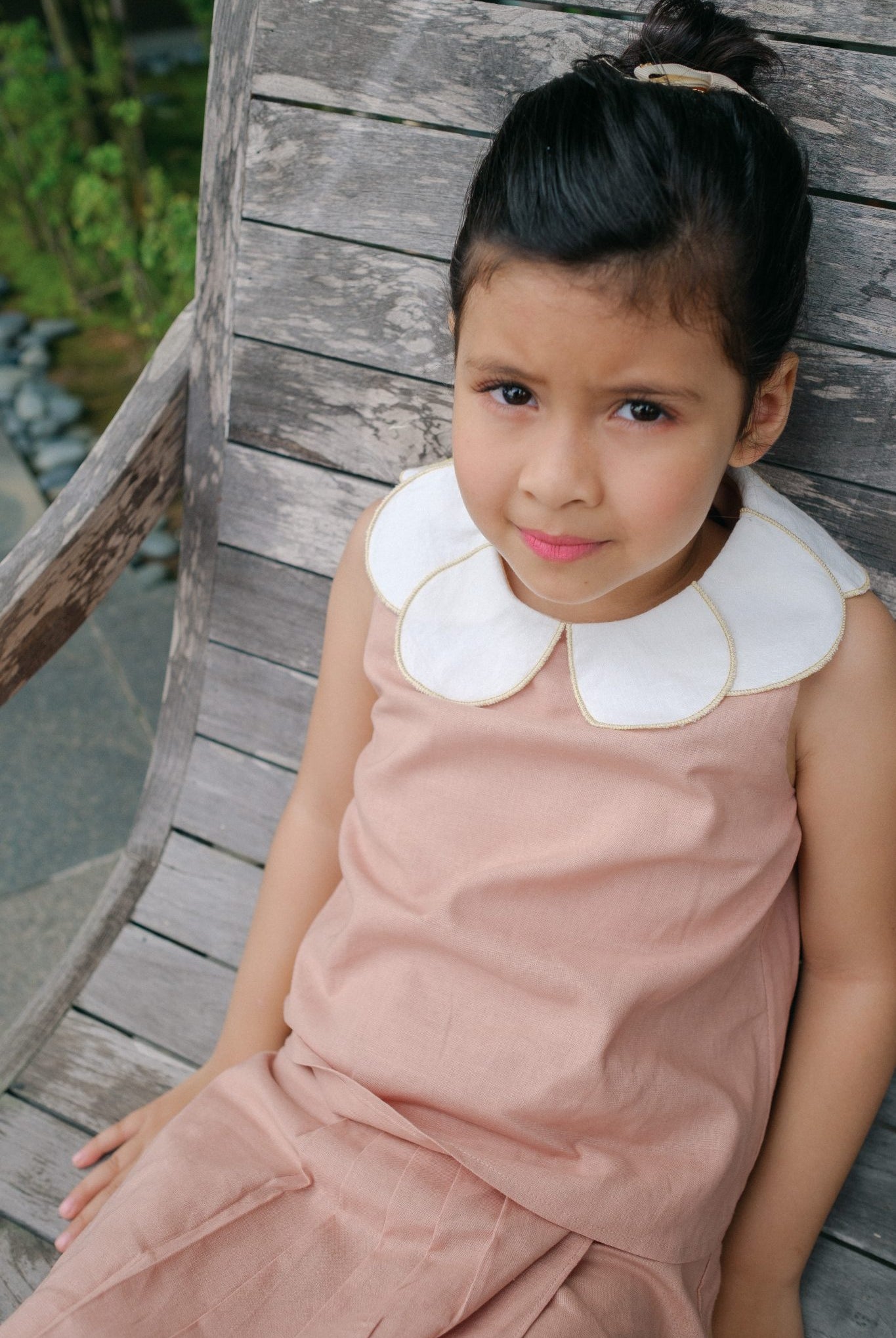 little girl wearing high quality pink dress by petit moi